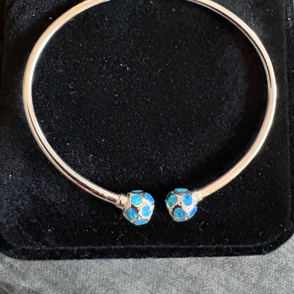 .925 sterling silver bangle bracelet with 8 mm balls at the end.
